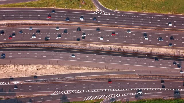 Descending over the multi-lane highways with lots of moving cars. The Garden State Parkway in Middlesex County, New Jersey from drone.