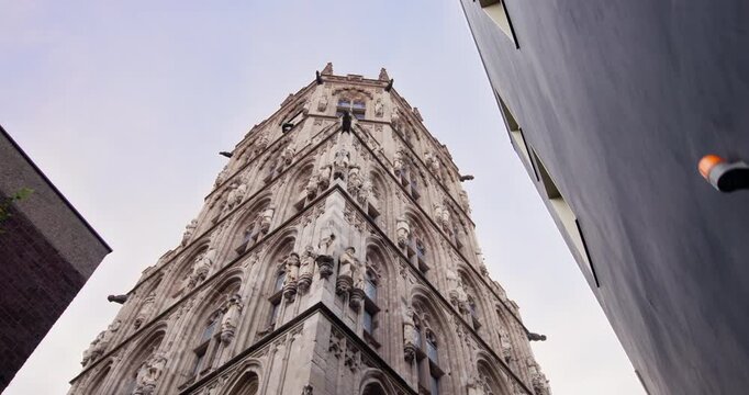 Historic Town Hall Tower rising above the Cologne cityscape with remarkable German architecture and charming urban scenery for European tourism and travel