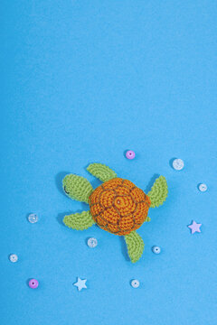 Summer crocheting concept. Handmade sharks and turtle, marine style. Set of different underwater animals