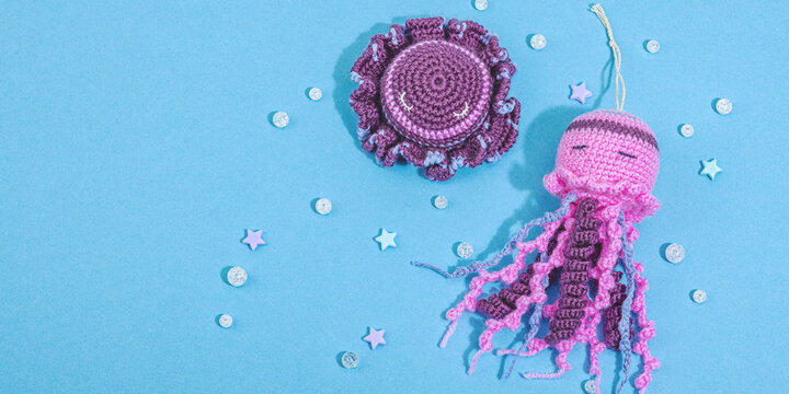 Summer crocheting concept. Handmade funny jellyfishes, marine style. Underwater animals