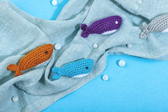 Summer crocheting concept. Handmade fishes, marine style. Underwater animals, different sharks