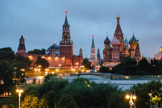 Evening view of Kremlin towers and colorful onion domes of cathedral under cloudy sky, with kremlin, cathedral