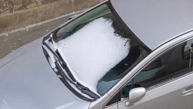 Aerial View of Car Windshield Blocked by Fresh Snow Winter Weather Transport Problem