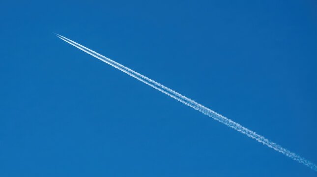 Airplane contrail across a blue sky