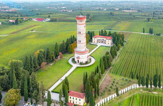 San Martino della Battaglia, Italy - 05 July 2026: Aerial view of the Torre Monumentale di San Martino della Battaglia surrounded by lush green vineyards and cypress trees.