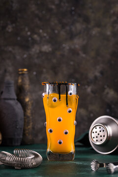 Spooky orange Halloween monster cocktail with eyes
