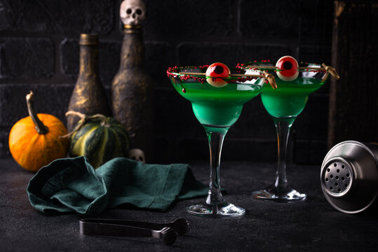 Spooky green Halloween monster cocktail with eyeball