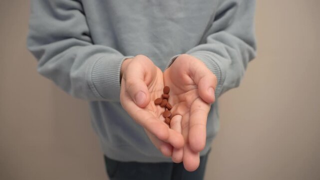 children's hands hide pills. Pills in children's hands