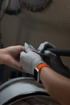Fine grinding of cuticle area during nail extension showing precise technician work for smooth material transition