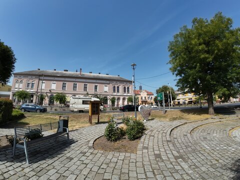 Dunafoldvar town center with pink buildings and cafe