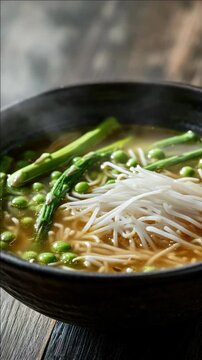 Steaming Bowl of Noodle Soup with Enoki Mushrooms and Asparagus