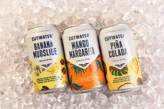IRVINE, CALIFORNIA - 28 AUG 2026: Three Cutwater cocktail cans on ice, Banana Mudslide, Pina Colada and Mango Margarita.