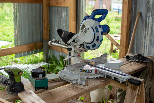 Electric miter saw on workbench in carpentry workshop