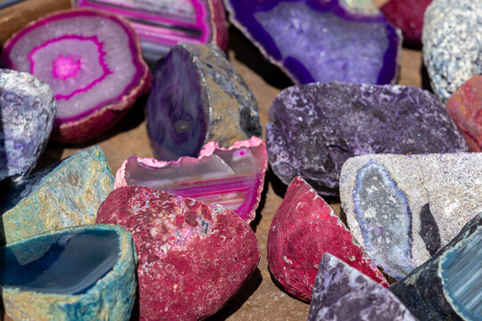 Agate, amethyst and quartz geodes cut open to reveal colorful crystal interiors. Geological scene suitable for science, education and decorative themes.