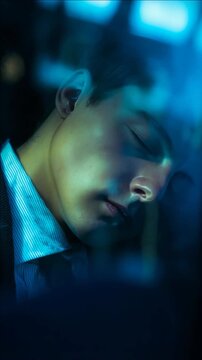 Close-up portrait of a young man sleeping in blue cinematic lighting