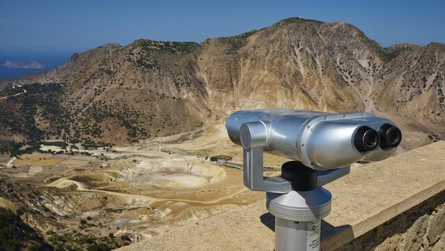 Silver telescope with a view of a vast mountain landscape in the background, volcanism, volcanic island, Profitis Elias church, Nisyros, Dodecanese, Greek Islands, Greece