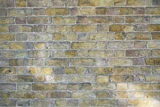 Brick wall with bright ochre-colored bricks, Chelsea, London, England, Great Britain, Great Britain