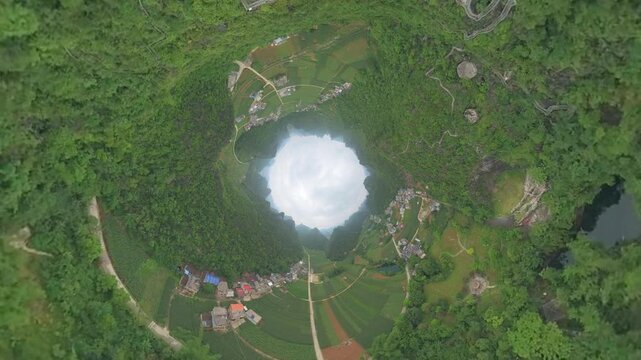 Drone view karst landscape of green mountains, pond, agriculture field and villages in Duan, Hechi, Guangxi, China. 4k real time footage travel concept high angle view.