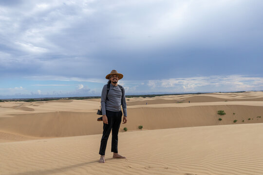 Young Latin Man Exploring the Desert Sand Dunes During Vacation in Falcon State, Venezuela