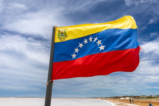 Flag of Venezuela waving over the Cumaraguas salt flats in Falc&oacute;n State.