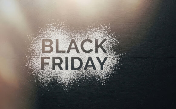 Black Friday sale concept with flour on dark wooden surface representing shopping discounts and seasonal promotions for retail marketing