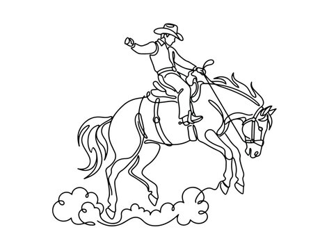 Cowboy riding bucking bronco at rodeo event