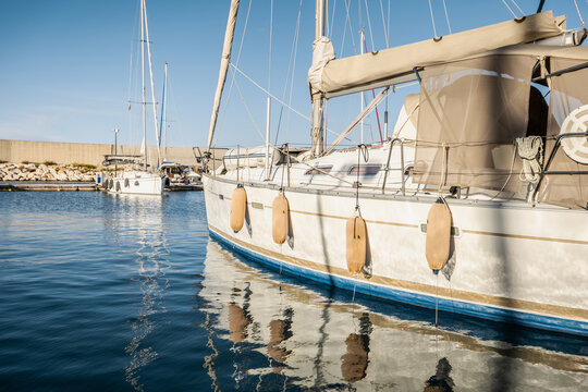 yachts docked in modern marina with shore power and water pedestals