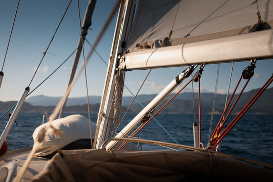 View from cockpit of sailing yacht heeling in open sea during summer travel