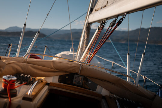 View from cockpit of sailing yacht heeling in open sea during summer travel
