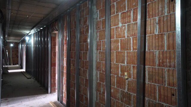 Camera inspection of hollow clay block wall with metal studs for drywall installation.