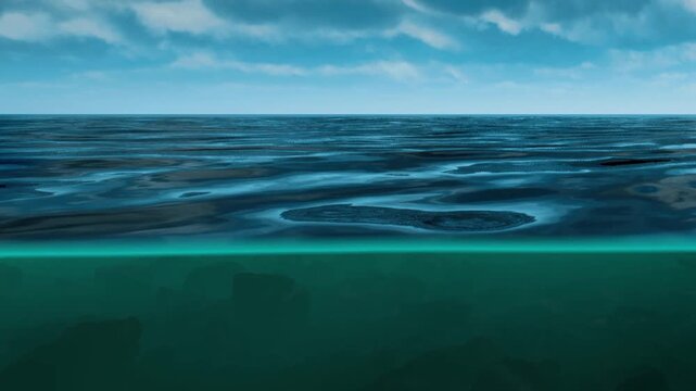The ocean surface shows a clear division between water above and below. Clouds are present in the sky above, reflecting over the serene water.