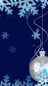 Animation of christmas baubles decorations with snow falling