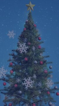 Animation of snowflakes icons over decorated christmas tree against blue background with copy space