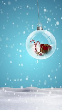 Animation of snow falling over christmas baubles in winter landscape