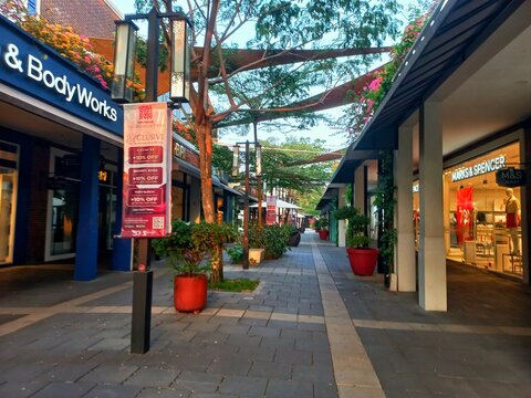 Karawang, Indonesia - August 11, 2026: Modern outdoor pathway and retail storefronts of Bath & Body Works and Marks & Spencer at Summarecon Villaggio Outlets mall.