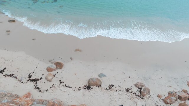 high view of waves gently crashing on beach