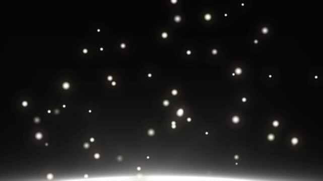 Golden bokeh light particles rising on dark background loop video