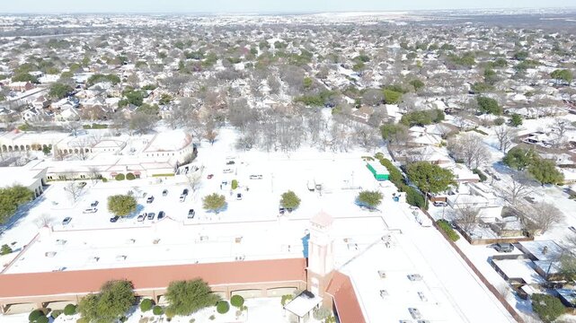 East Sandy Lake Road corridor passes St Ann Catholic Parish campus within DFW suburbs. Severe freeze blankets institutional complexes, surrounding neighborhood lots in Coppell, Texas