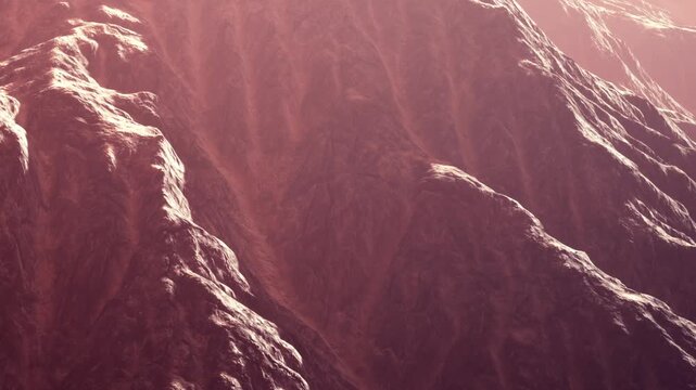 The scene shows mountains with rough textures illuminated in reddish tones during sunset. Shadows fall on the rocky surfaces, highlighting the landscapes details.