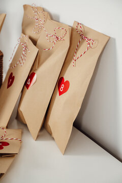 Closeup Handmade rustic advent calendar bags with small gifts for christmas eve countdown