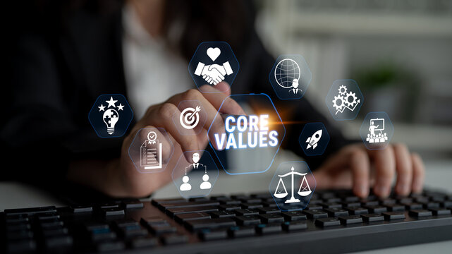 Professional Hand Typing on Keyboard with Core Values Visuals and Business Icons Representing Teamwork, Integrity, and Innovation in Modern Workplace Fluxor.