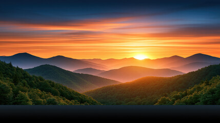 Obraz premium Sunset mountain landscape with layered ridge and glowing sky