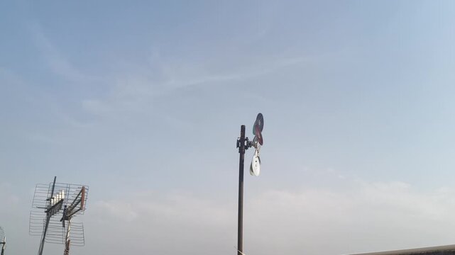Detailed view of a small weather anemometer or DIY wind power model turning on a roof