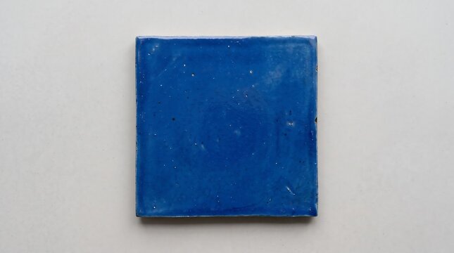 Blue square ceramic tile on neutral background