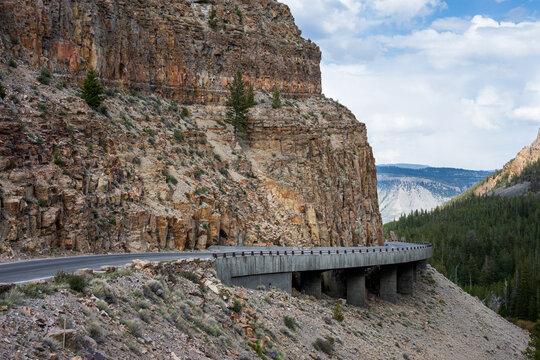 Grand Loop Road to Kingman Pass by a fractured rock cliff wall, The Golden Gate area, traveling in Yellowstone National Park for summer vacation
