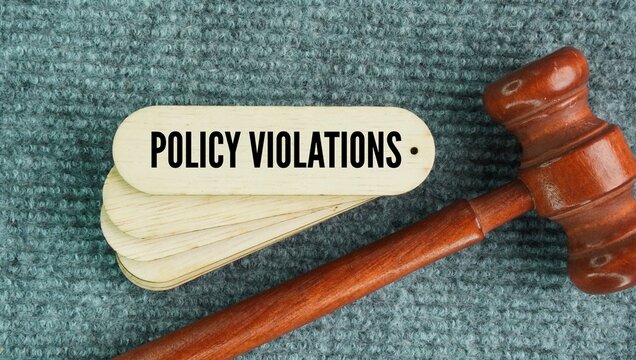 Judge's gavel and stick with the words Policy Violations. when a person or system breaks an established rule, guideline, or standard set by an authority, company, or platform.