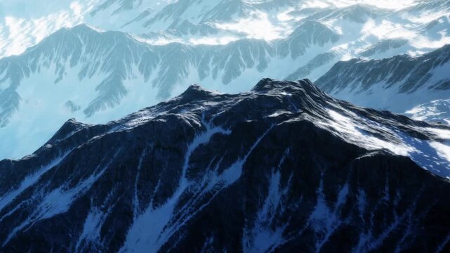 A snow covered mountain range with rocky peaks. The sunlight shines on the slopes while shadows create patterns on the snow. The view appears high and distant.