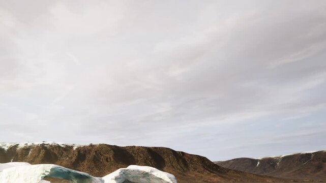 A landscape with large ice formations and mountains under a cloudy sky. The location appears to be a cold area with snow on the ground and hills.