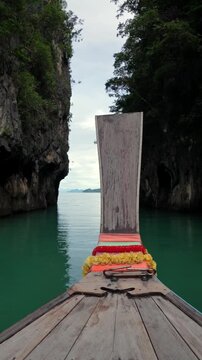 Traditional thai long tail boat navigating a lagoon