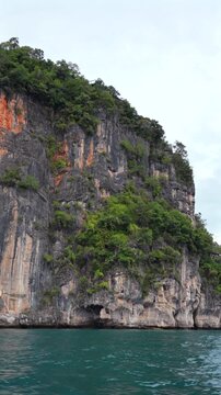Sailing past tropical limestone cliffs in thailand